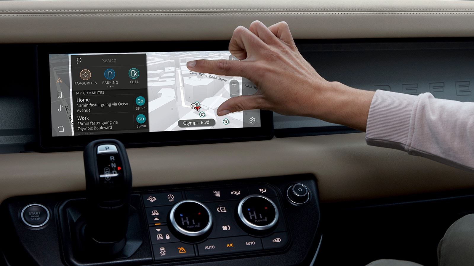 a hand interacting with a touchscreen map in a vehicle